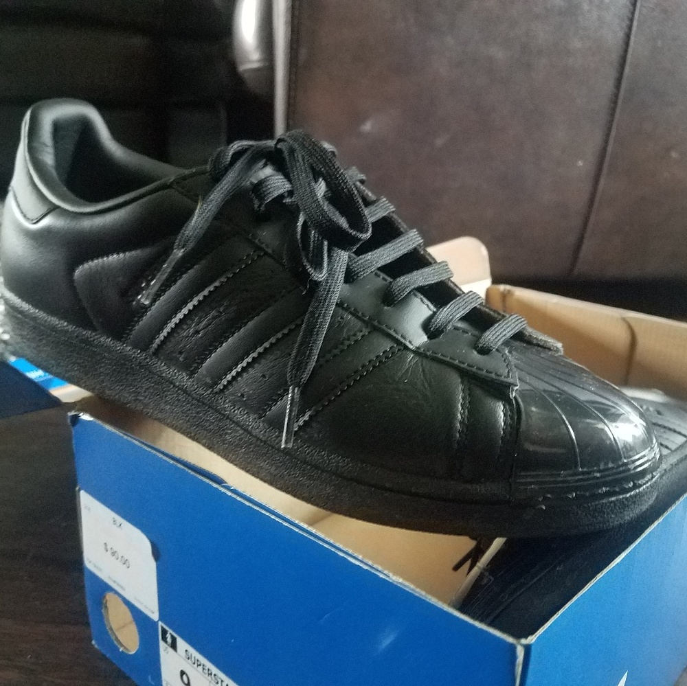 solid black Adidas shell toe